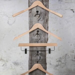 Vier naturfarbene Holzbügel mit mittlerem Hosenbügel, vertikal präsentiert – Warme Holzoptik für klassische Kollektionen.