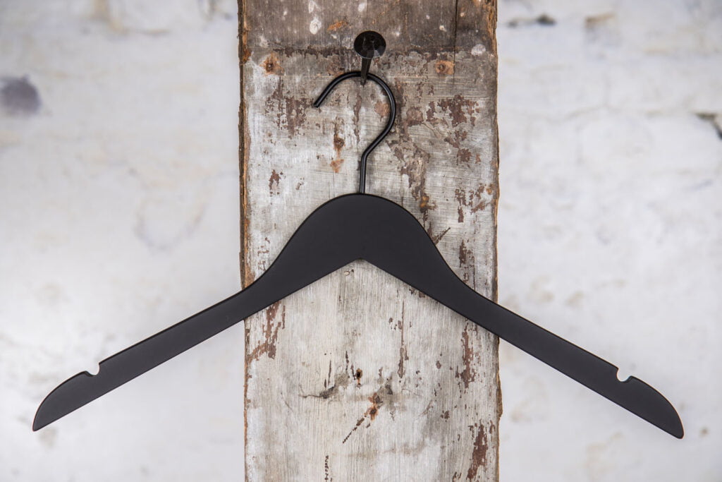 Black shirt hanger with structured surface – Premium design for presentation rooms.