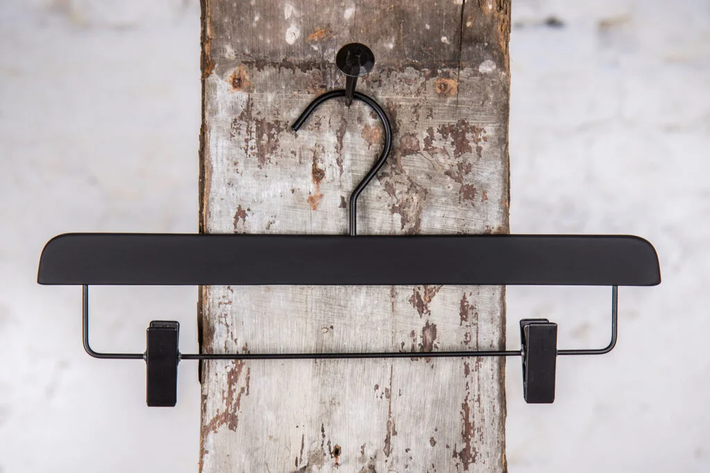 Black trouser hanger with metal rod and black clips - Modern clip hanger with stable suspension.