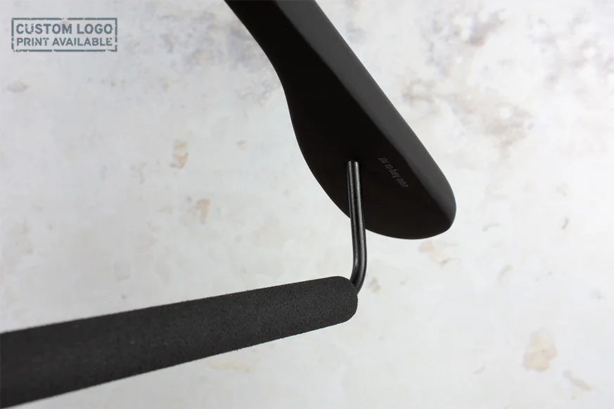 Nahaufnahme der Unterseite eines schwarzen Kleiderbügels mit Querstange – Fokus auf Material und Funktionalität.