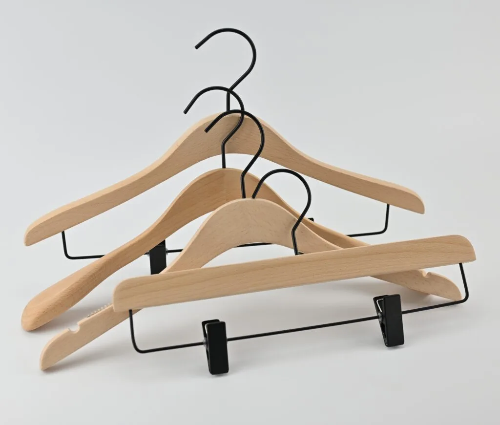 Natural-colored wooden hangers with black metal hangers and trouser clips