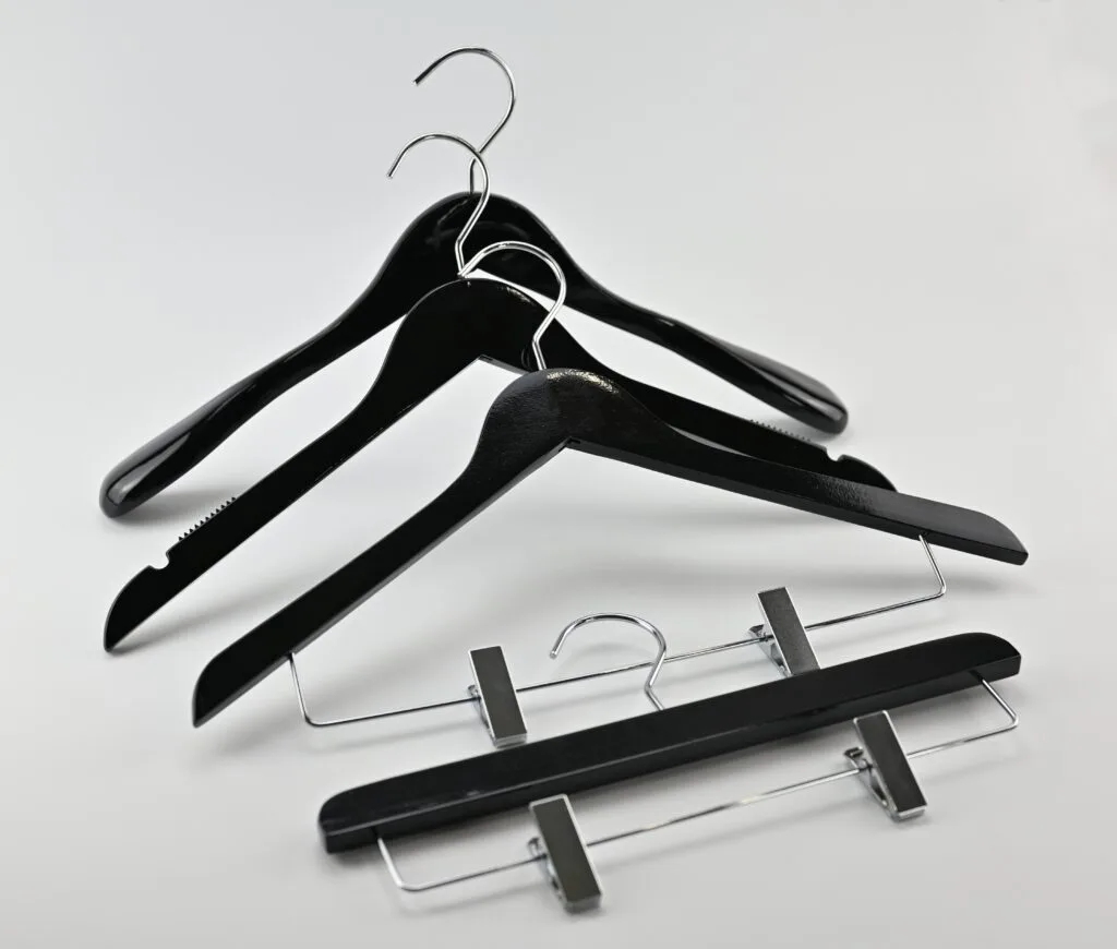 Black wooden hangers with glossy finish, chrome hooks and trouser hangers with clips