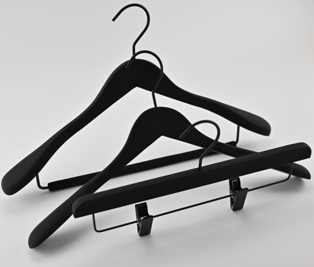 Black wooden hangers with a matte finish, black metal hangers and trouser clips