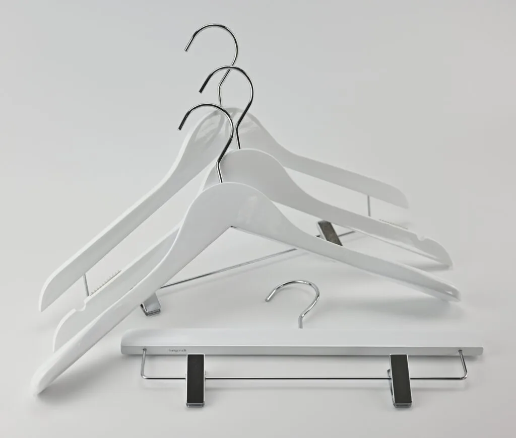 White wooden hangers with chrome metal hangers and trouser hanger with clips