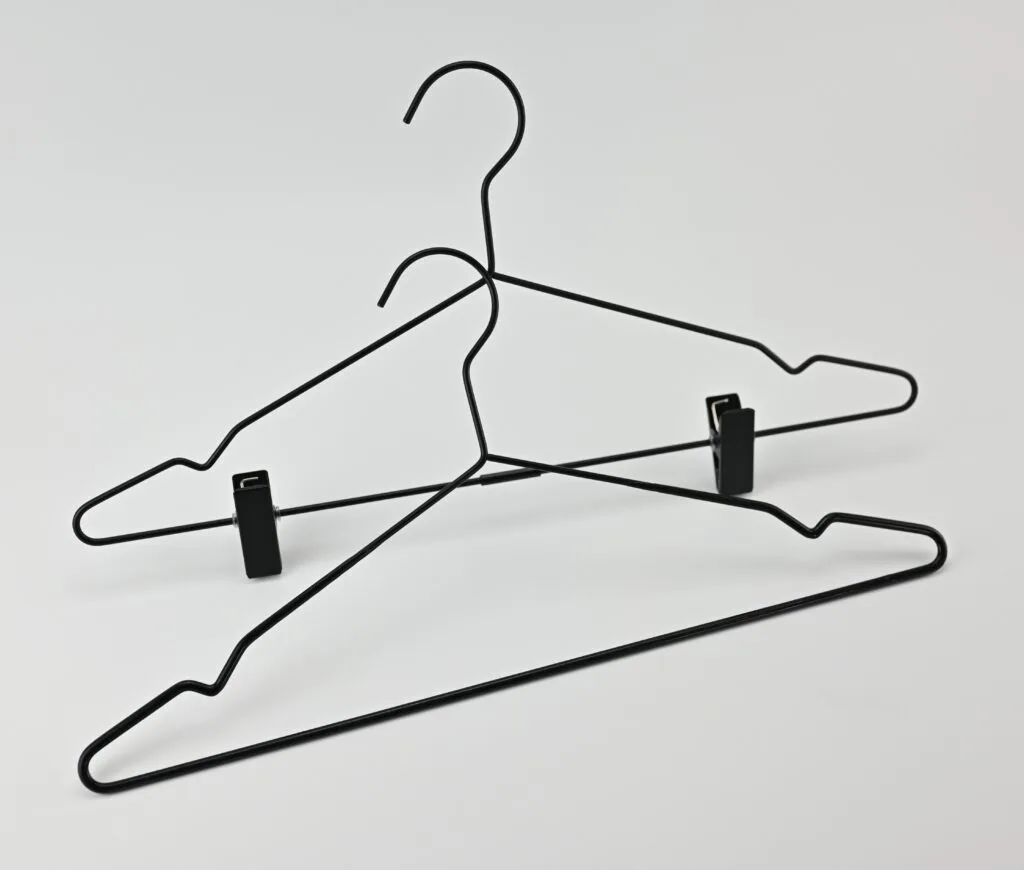 Black metal hangers with clips for trousers and skirts